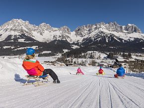 Tobogganing with the family as a winter sport in Scheffau am Wilden Kaiser